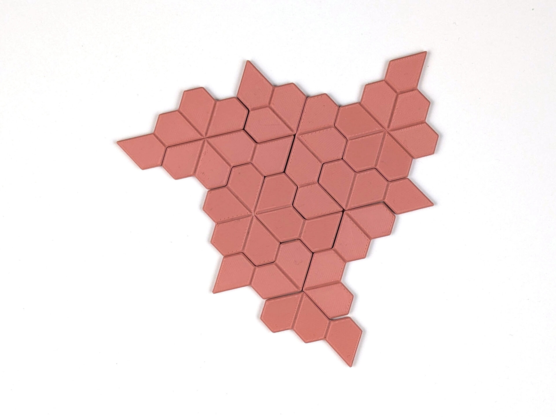 Floret shape with threefold rotational symmetry made from twelve 3D-printed puzzle pieces